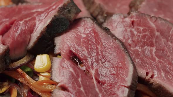 Rotating Close Up Rare Medium Cooked Beef and Grilled Vegetable Salad alt