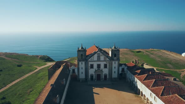 Drone flight over the ancient church on the Earth's edge; Portugal