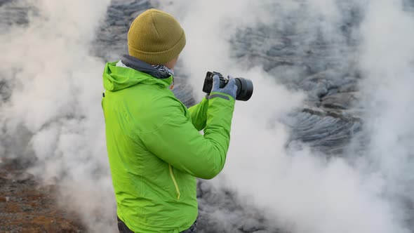 Photographer With Camera By Lava Flow From Erupting Fagradalsfjall Volcano alt