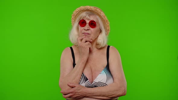 Thoughtful Senior Woman Tourist Thinking Over Idea Imagining Plan in Mind Doubts About Answer alt