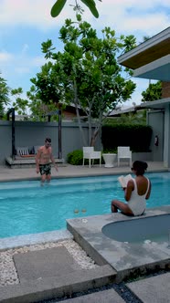 Couple Men and Woman in Infinity Pool Asian Woman and European Men Enjoying the Pool Swimming Pool alt