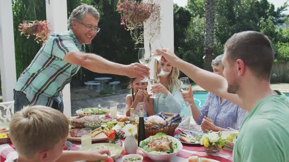 Happy family eating together at table alt