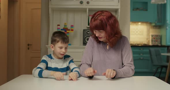 Autism Therapist Playing Finger Game with Kid with Autism alt