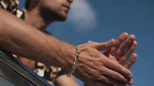 Man Showing a Bracelet on His Wrist alt