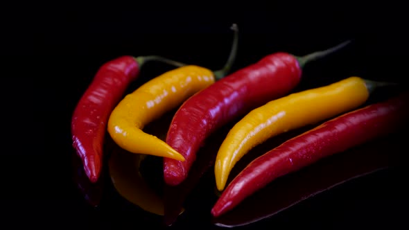 Hot chilli peppers isolated rotating on a black background. 
