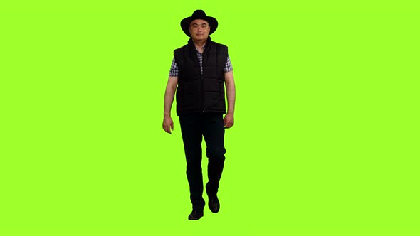 Adult Man Walking in Black Vest And Cowboy Hat