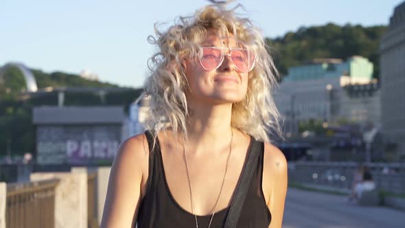 Happy blonde woman walking.