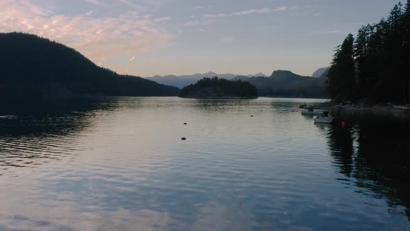 Rocky Shore Of Sechelt Inlet With A Calm Water On A Summer Sunset - A Pacific Ocean fjord On The Sun alt