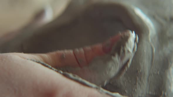 Hands of Sculptor Modeling Clay alt