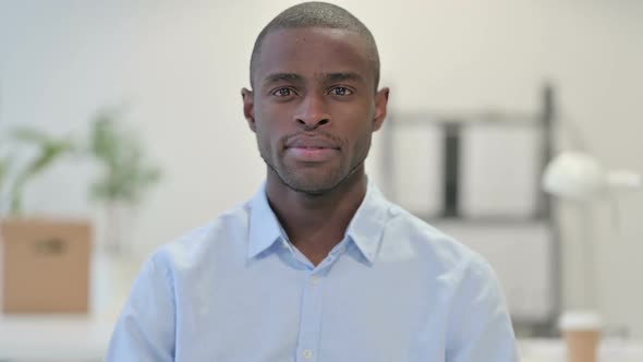 Portrait of African Man Looking at Camera in Office alt