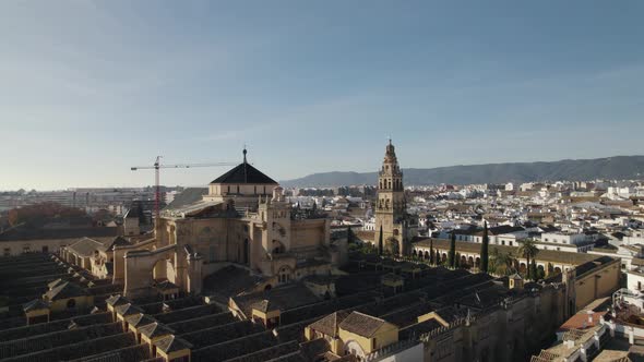 Mezquita Cathedral of Cordoba in Spain with crane in background. Aerial drone panoramic view.