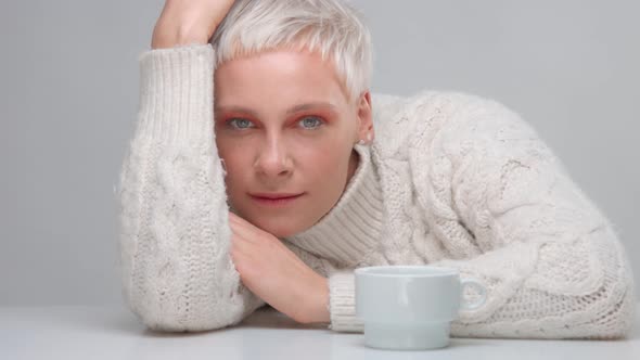 Blond Woman with Short Haircut Wears Knitted Sweater