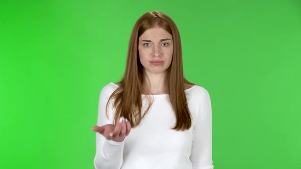 Portrait of Pretty Young Perplexed Woman Is Points To the Viewer and Says That You Are Serious. alt