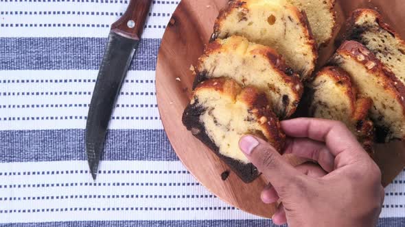 Top View of Hand Pick Bakery Cake on Chopping Board . alt