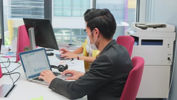 Portrait of Business man wear face mask due to Covid19 and work in office with new normal lifestyles alt