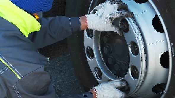 Worker Make Repair Wheels Truck Close Up. Person Twist Screw Wrench Use Hand .