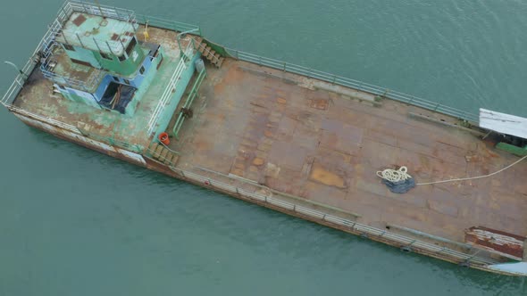 Aerial footage, moving from a top down view to a sideview of a ferry alt