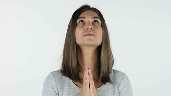 Praying Beautiful Girl for Forgiveness, White Background in Studio alt
