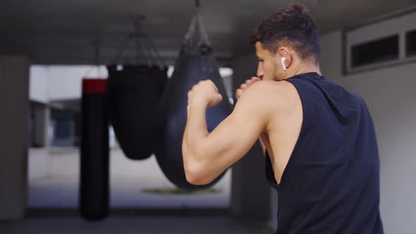 Martial Art Fighter Does Shadow Boxing Kickboxer Training Strikes in Gym alt