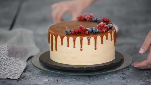 Pastry Chef Decorate Caramel Cake with Frozen Summer Berries