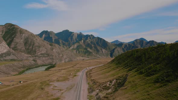 Mountains of Altai with traffic cars on Chuya highway