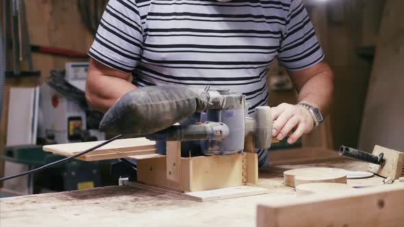 Craftsman Working with Grinding Machine at Wood Workshop