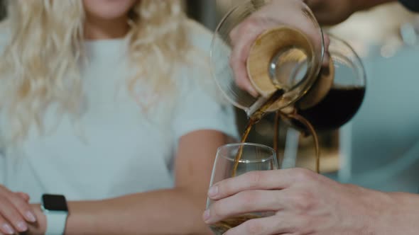 Barista making the aroma of  Filter coffee for female costumer. alt