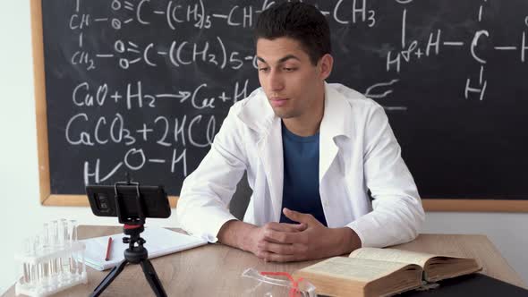 Online Chemistry Lesson Male Teacher Gives a Lecture on Video Link Blogger Teacher Teaches Students alt