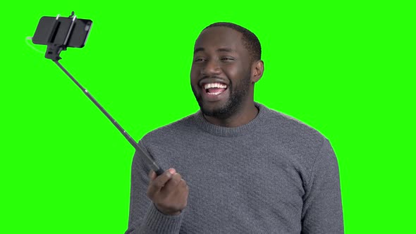 Afro American Guy Taking a Selfie with Monopod. alt