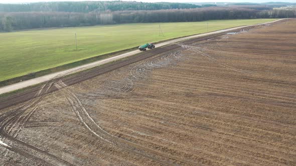 tractor carrying organic fertilizer top view from drone.