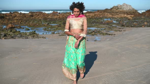 Woman in Traditional Wear Seen Walking Seaside