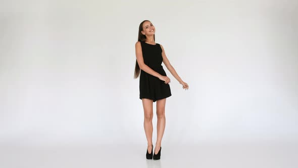 Pretty Happy Girl In Short Dress Dancing On White Background