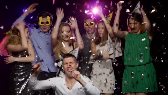 Young People Dancing and Throws Glitter Confetti at the Party alt