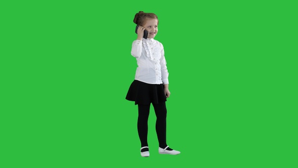 Happy girl with mobile phone Isolated on a Green Screen alt