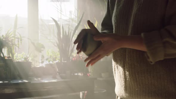 Piece of Raw Clay Shaped Into Ball By Potter alt