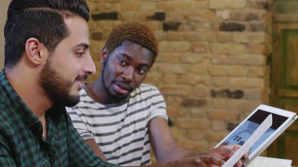 Mixed-Raced Male Designers Discussing Project 