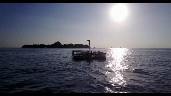 Family of two sunbathing on beautiful coast beach voyage by clear lagoon with bright sandy backgroun alt