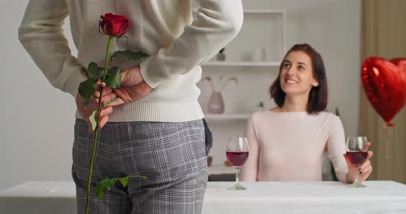 View From Behind Man Young Handsome Romantic Boyfriend Holding Red Rose in His Hand alt