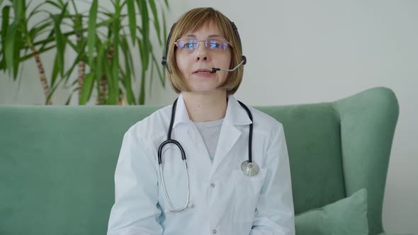 Older Woman Doctor Therapist Wearing Headset Video Call Talking to Web Camera Consulting Virtual alt