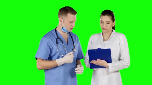 Two Doctors Talking Together. Green Screen alt