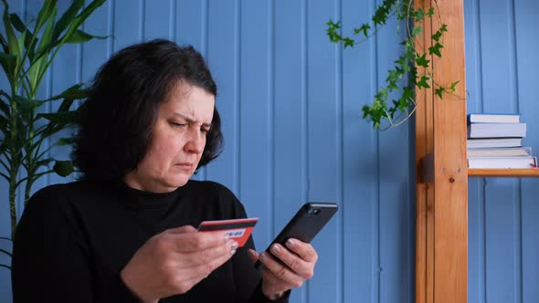 Old Woman Online Shopping at Home on Smartphone Typing Credit Card Number and Cancel the Purchase