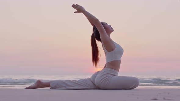 Young woman practicing yoga at the beach front for healthy mind and perfect body alt