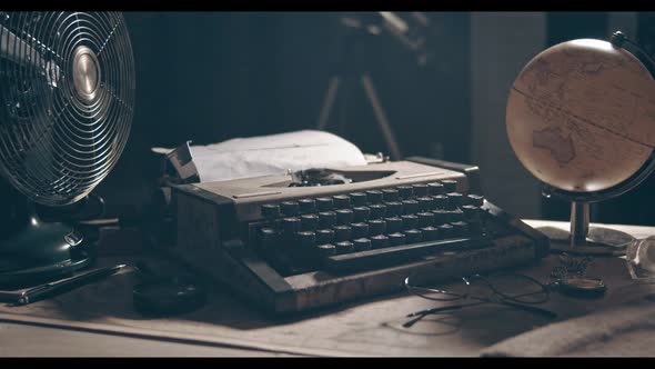 Light Revealing Typewriter. 1950s Scene Setup. Film or Movie Opening Shot