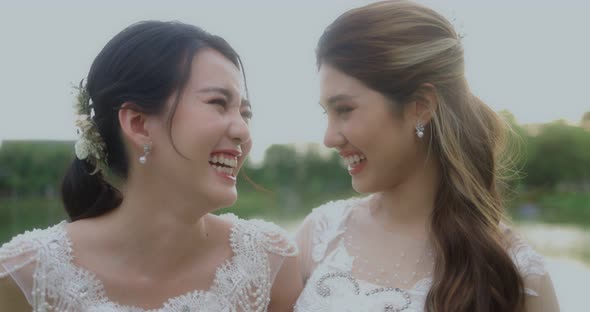 Happy Asian Lesbian Married Couple Enjoying Romantic Moments Outside, Slow Motion. alt