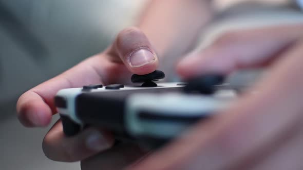 Boy playing video game using joystick, close up