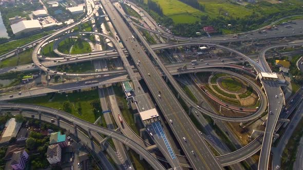 Aerial View of Highway Road Interchange with Busy Urban Traffic Speeding on Road alt