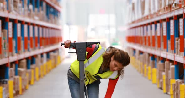 Female warehouse worker cleaning warehouse floor alt