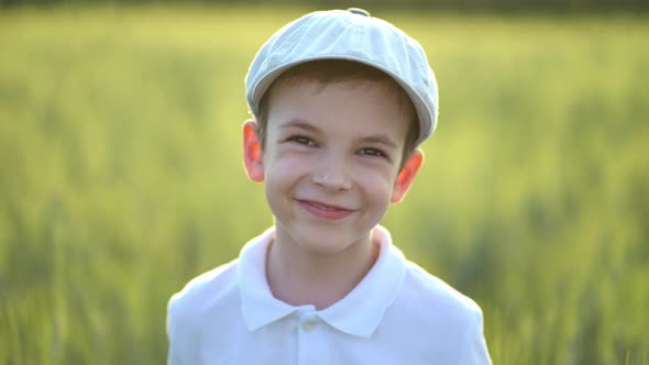 Portrait of Boy Standing in Fresh Green Wheat Field alt