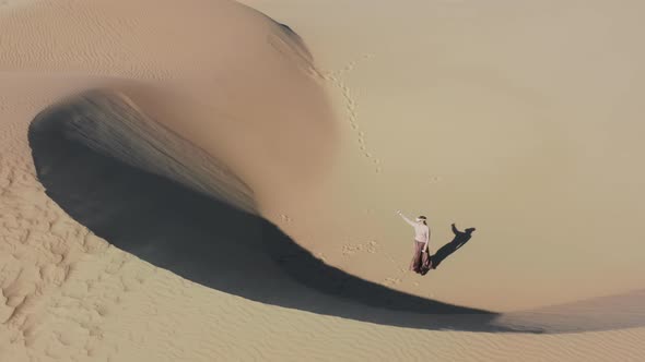 Woman Creating Futuristic World of Future in AR Googles at Sand Dunes  Aerial alt