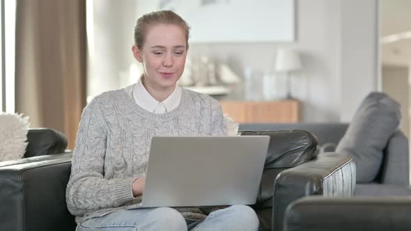Cheerful Woman Doing Video Call on Laptop at Home  alt